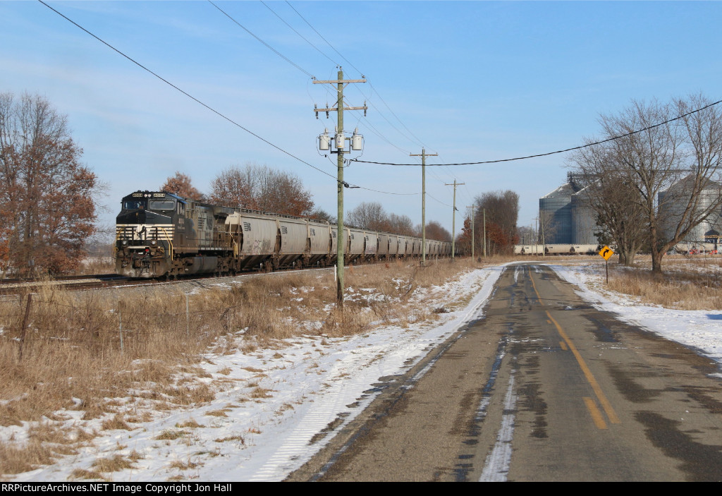 One of NS's Mane painted rebuilds provides the power for an outbound grain train